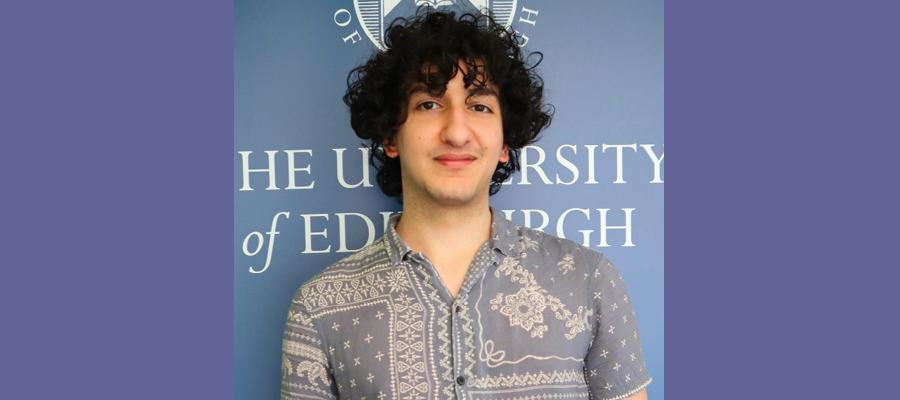 Ammir Barakat Ammir Barakat standing in front of the University of Edinburgh logo.